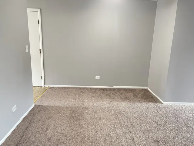 an empty room with closet and a bathroom
