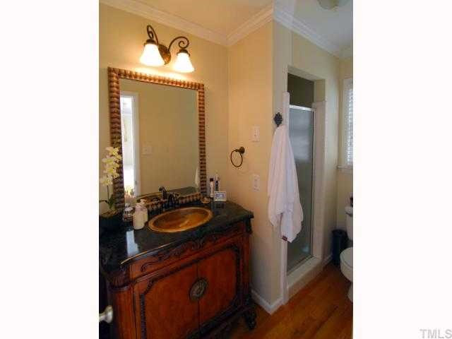 1201 Hunting Ridge Road Raleigh, NC 27615 - Photo 7 of 11 The elegant master bath is accentuated by the decorative vanity and sink. The master bath has hardwood floors and tiled shower. Master Bath/Spa