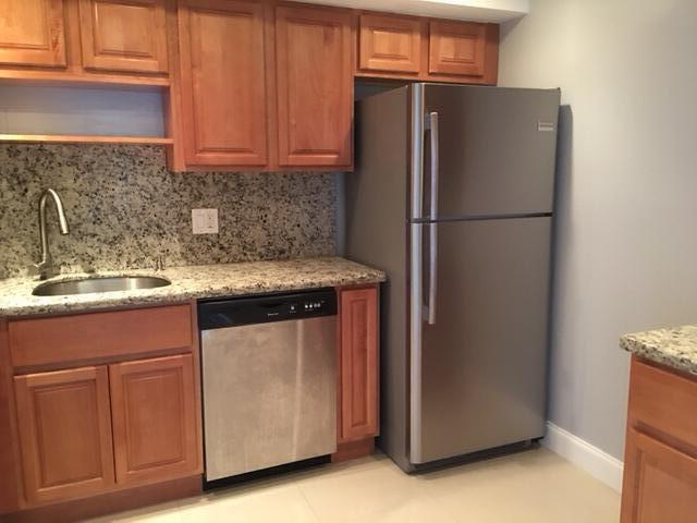 4154 Inverrary Drive, Unit 407 Lauderhill, FL 33319 - Photo 1 of 39 a kitchen with stainless steel appliances granite countertop a refrigerator a sink and a stove