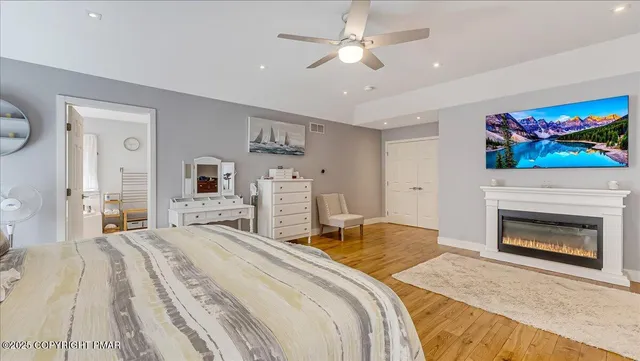 an aerial view of residential house with outdoor space and trees all around