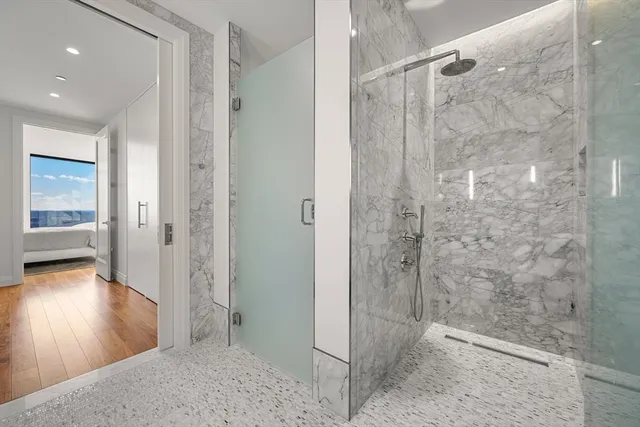 a bathroom with a shower and a glass door