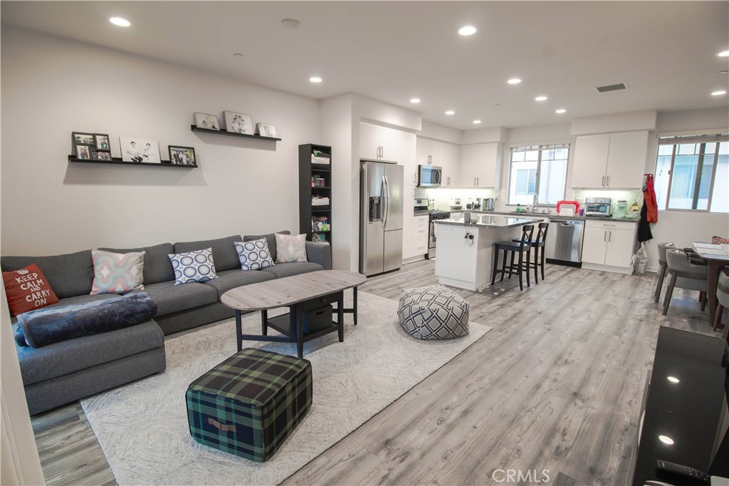170 Harringay Irvine, CA 92618 - Photo 1 of 1 a living room with furniture a wooden floor and kitchen view