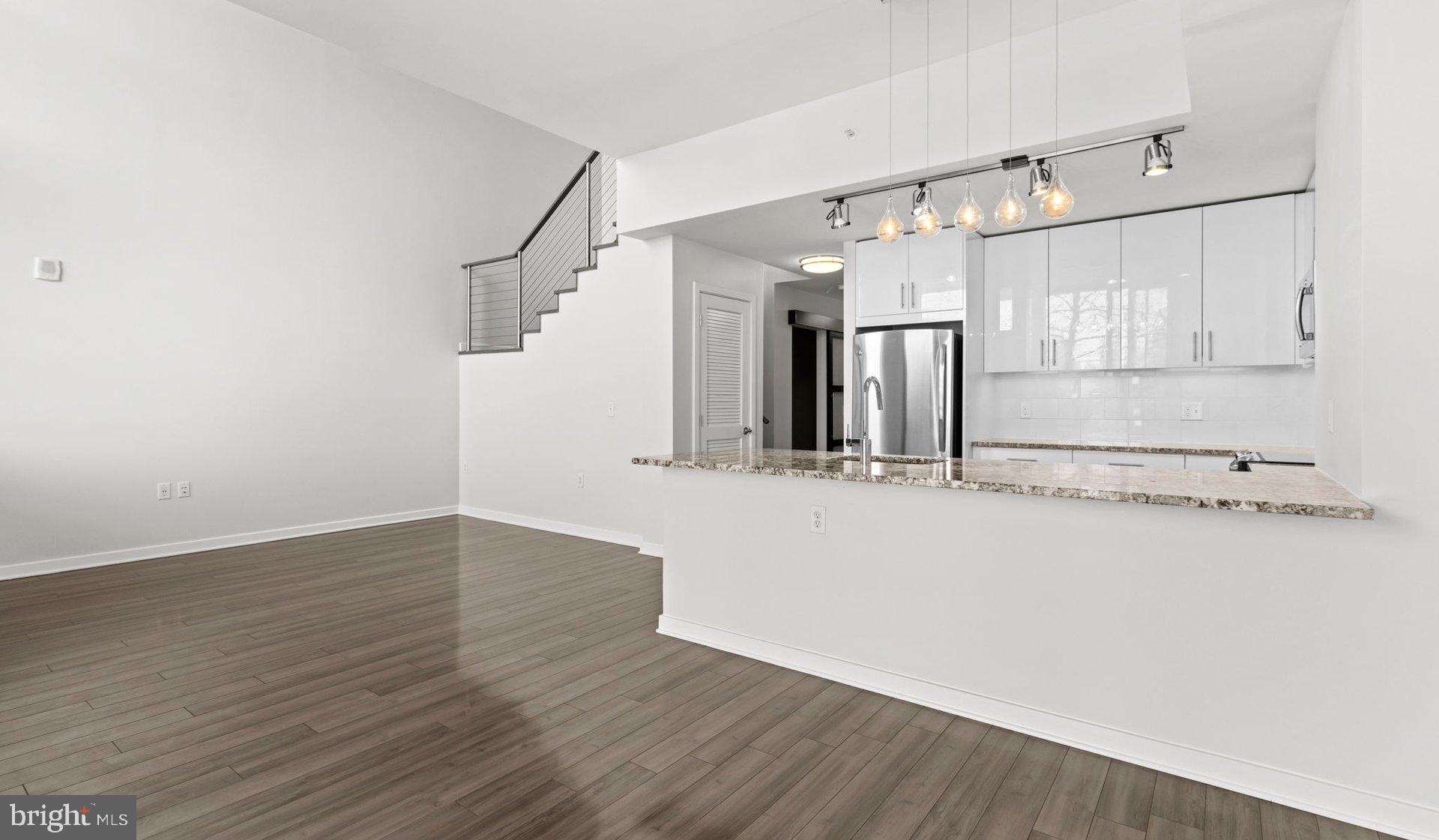 8300 Wisconsin Avenue, Unit 1B1918 Bethesda, MD 20814 - Photo 1 of 150 a view of a room with wooden floor and white walls
