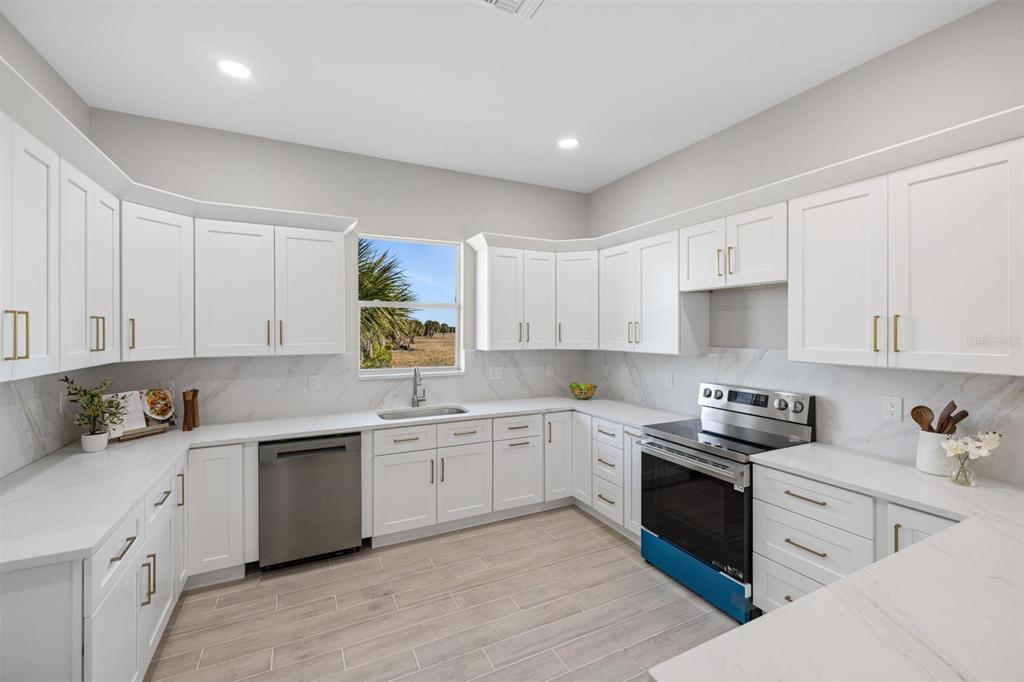 38 Lark Drive Placida, FL 33946 - Photo 17 of 46 a kitchen with a sink white cabinets and white appliances