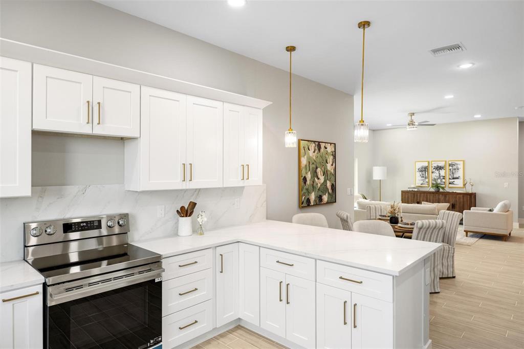 38 Lark Drive Placida, FL 33946 - Photo 18 of 46 a kitchen with white cabinets and stainless steel appliances