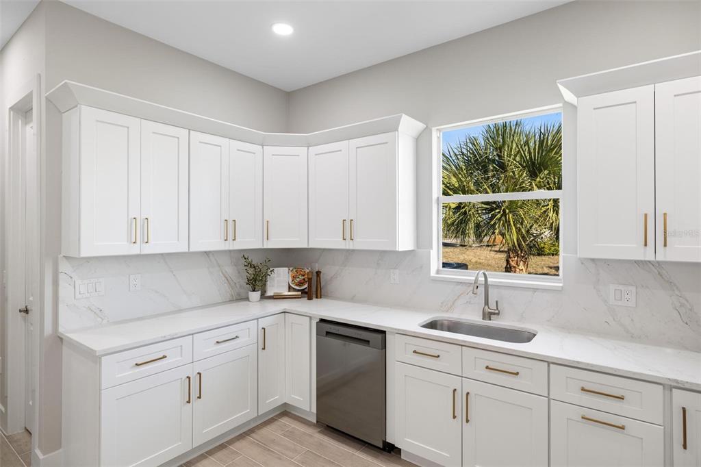 38 Lark Drive Placida, FL 33946 - Photo 19 of 46 a kitchen with white cabinets and window