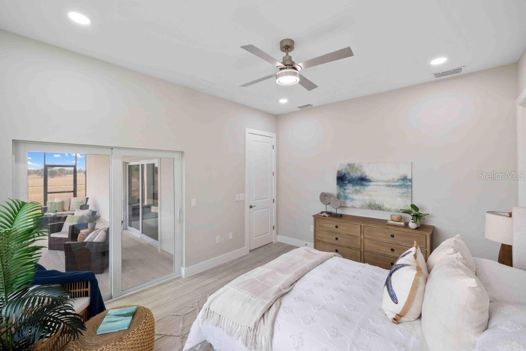 38 Lark Drive Placida, FL 33946 - Photo 23 of 46 a bedroom with a bed and wooden floor