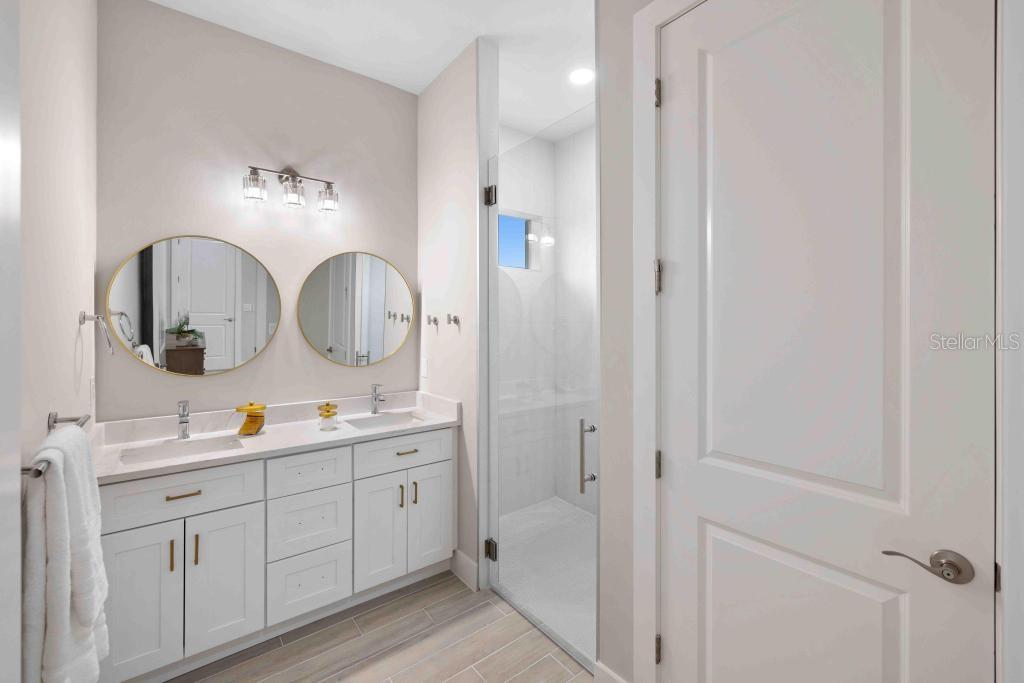 38 Lark Drive Placida, FL 33946 - Photo 24 of 46 a en suite bathroom with a double vanity sink and a mirror