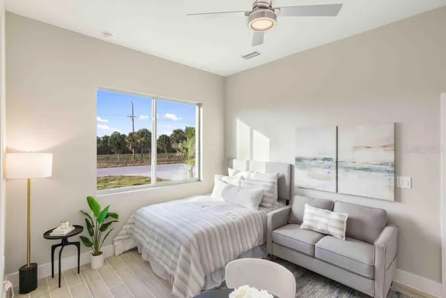 a spacious bedroom with a bed and a couch