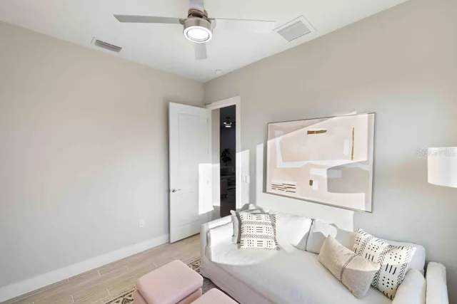 a living room with furniture and a wooden floor
