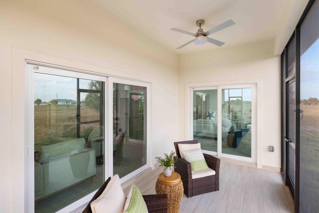 38 Lark Drive Placida, FL 33946 - Photo 38 of 46 a living room with furniture and a floor to ceiling window