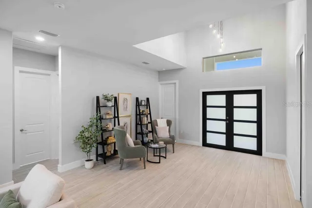 a view of a room with chairs and flower pot
