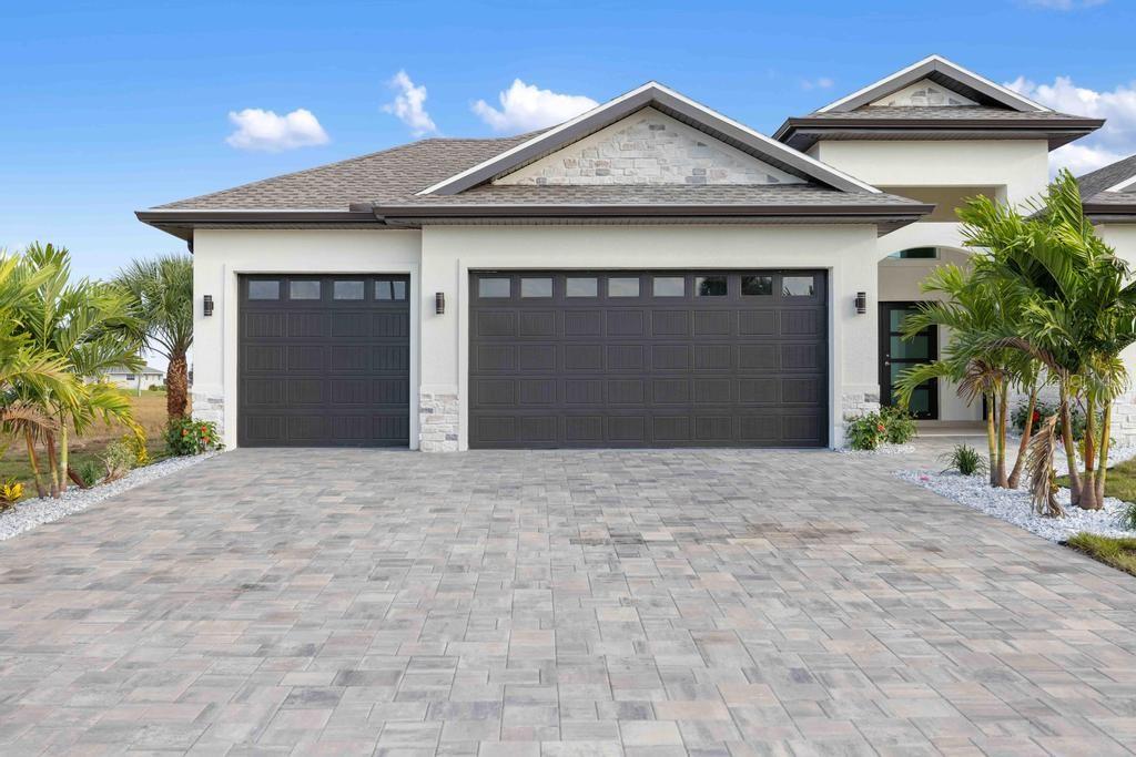 38 Lark Drive Placida, FL 33946 - Photo 45 of 46 a front view of a house with a yard and garage