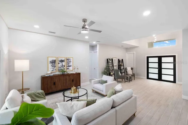 a living room with furniture and wooden floor