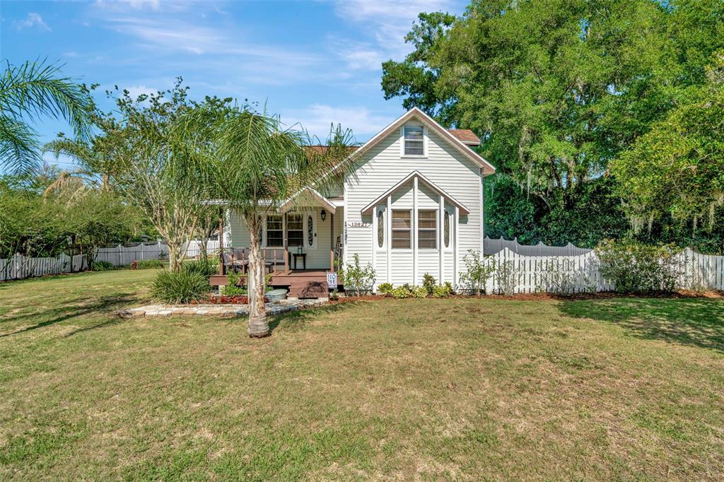 a view of a house with backyard and sitting area