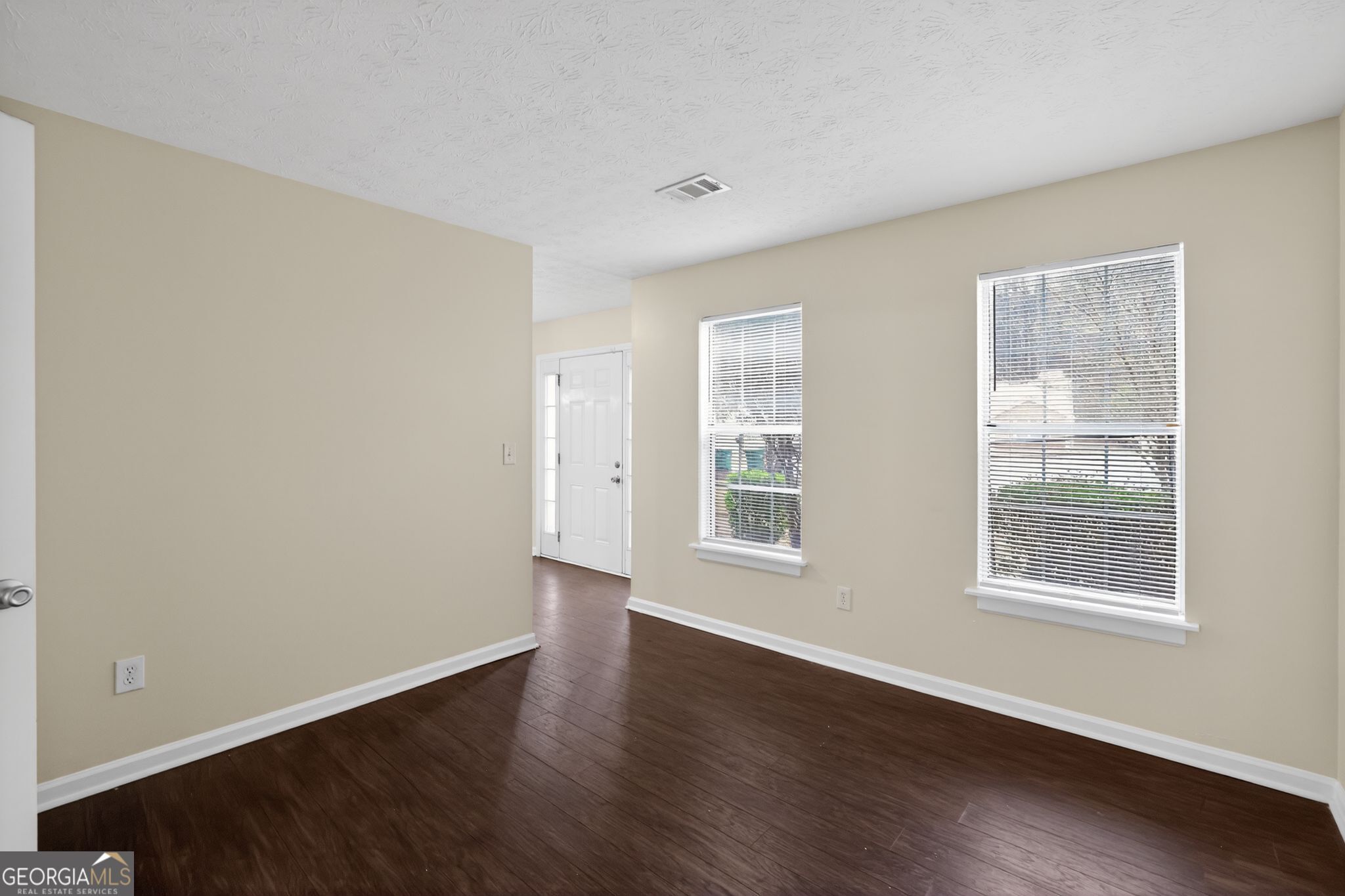 5635 Hunters Crossing Court Lithonia, GA 30038 - Photo 11 of 35 an empty room with wooden floor and windows