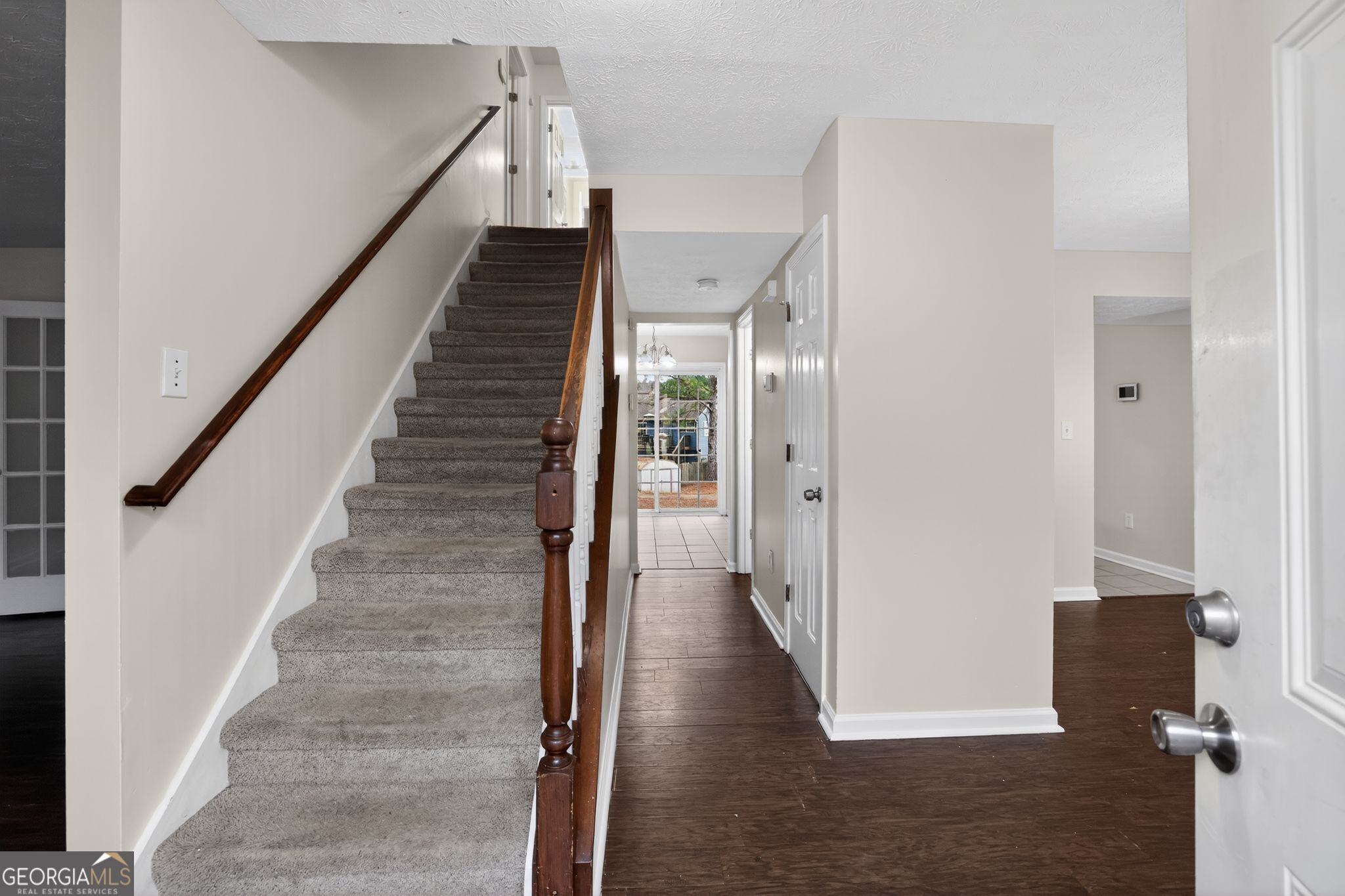 5635 Hunters Crossing Court Lithonia, GA 30038 - Photo 16 of 35 a view of a hallway with wooden floor and staircase