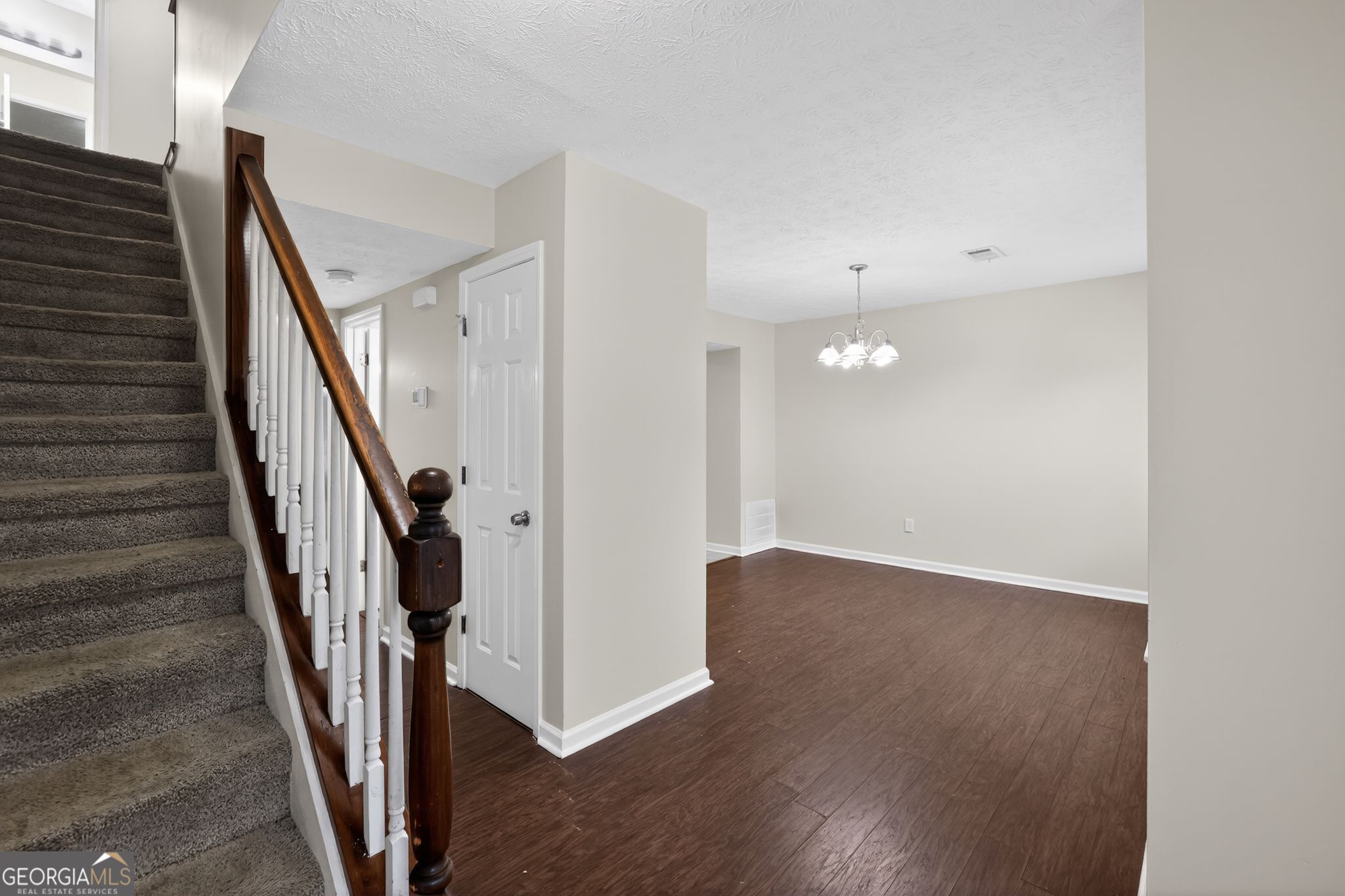 5635 Hunters Crossing Court Lithonia, GA 30038 - Photo 17 of 35 a view of a hallway with wooden floor and staircase