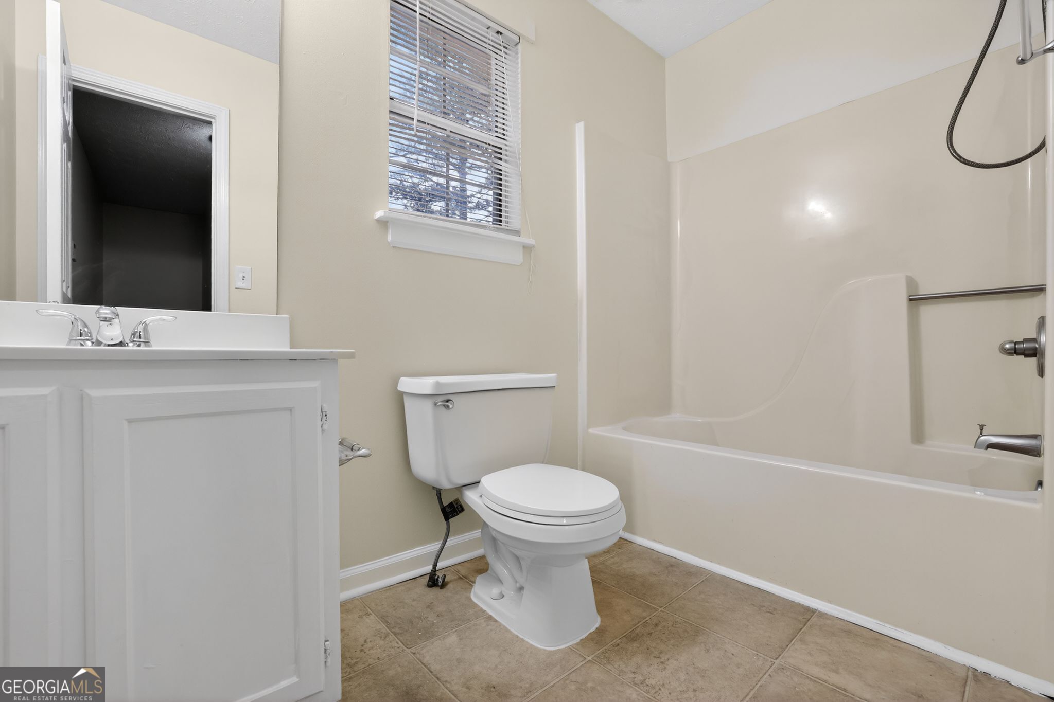 5635 Hunters Crossing Court Lithonia, GA 30038 - Photo 27 of 35 a bathroom with a sink toilet and a mirror