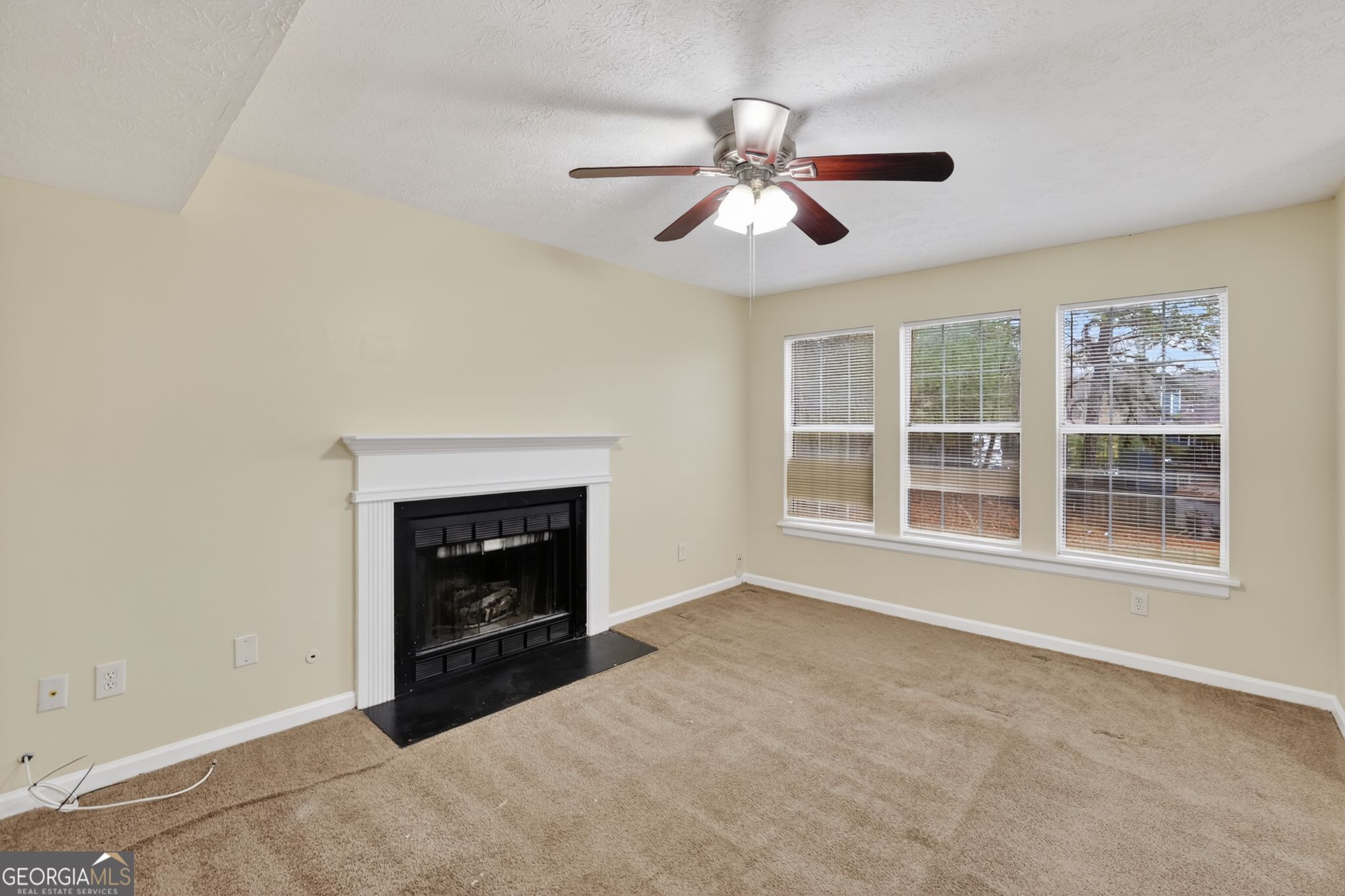 5635 Hunters Crossing Court Lithonia, GA 30038 - Photo 6 of 35 a view of an empty room with window and fire place