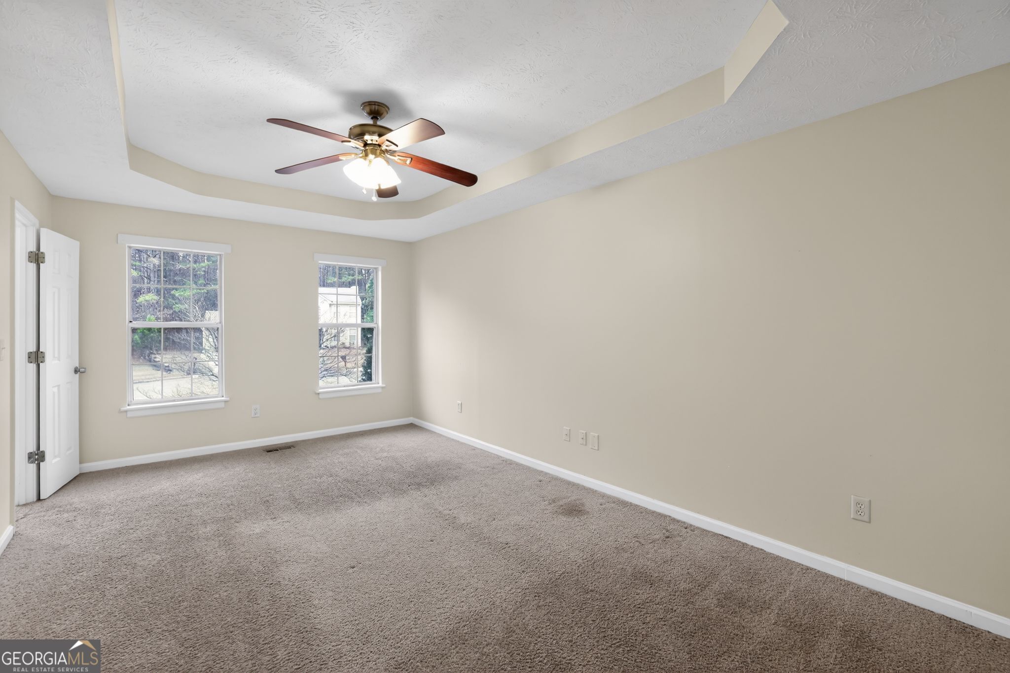 5635 Hunters Crossing Court Lithonia, GA 30038 - Photo 10 of 35 an empty room with windows and fan