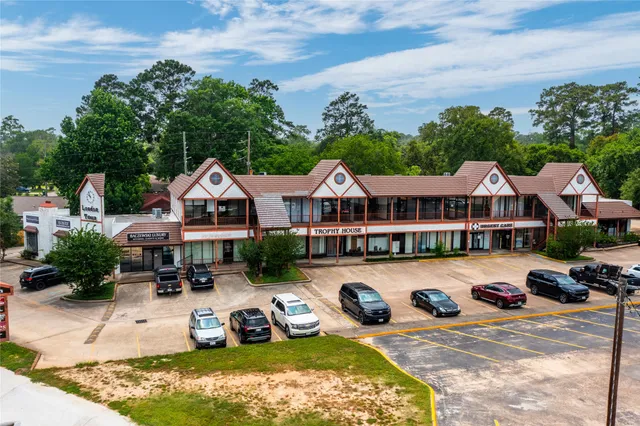 a front view of a house with yard and green space