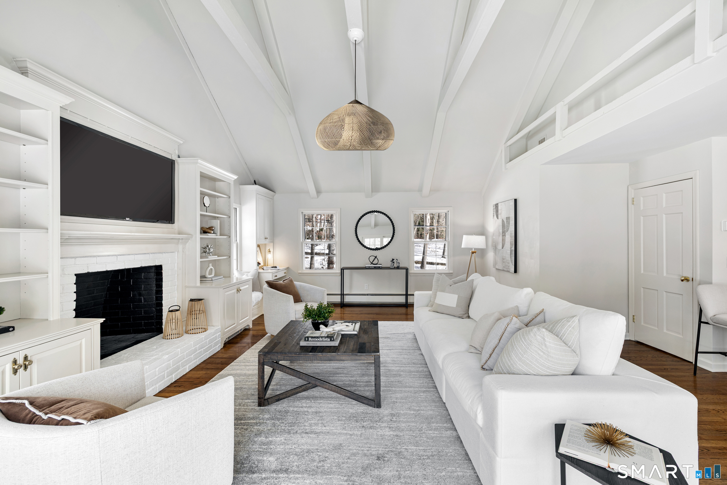 1038 West Road New Canaan, CT 06840 - Photo 14 of 37 a living room with furniture a fireplace and a flat screen tv