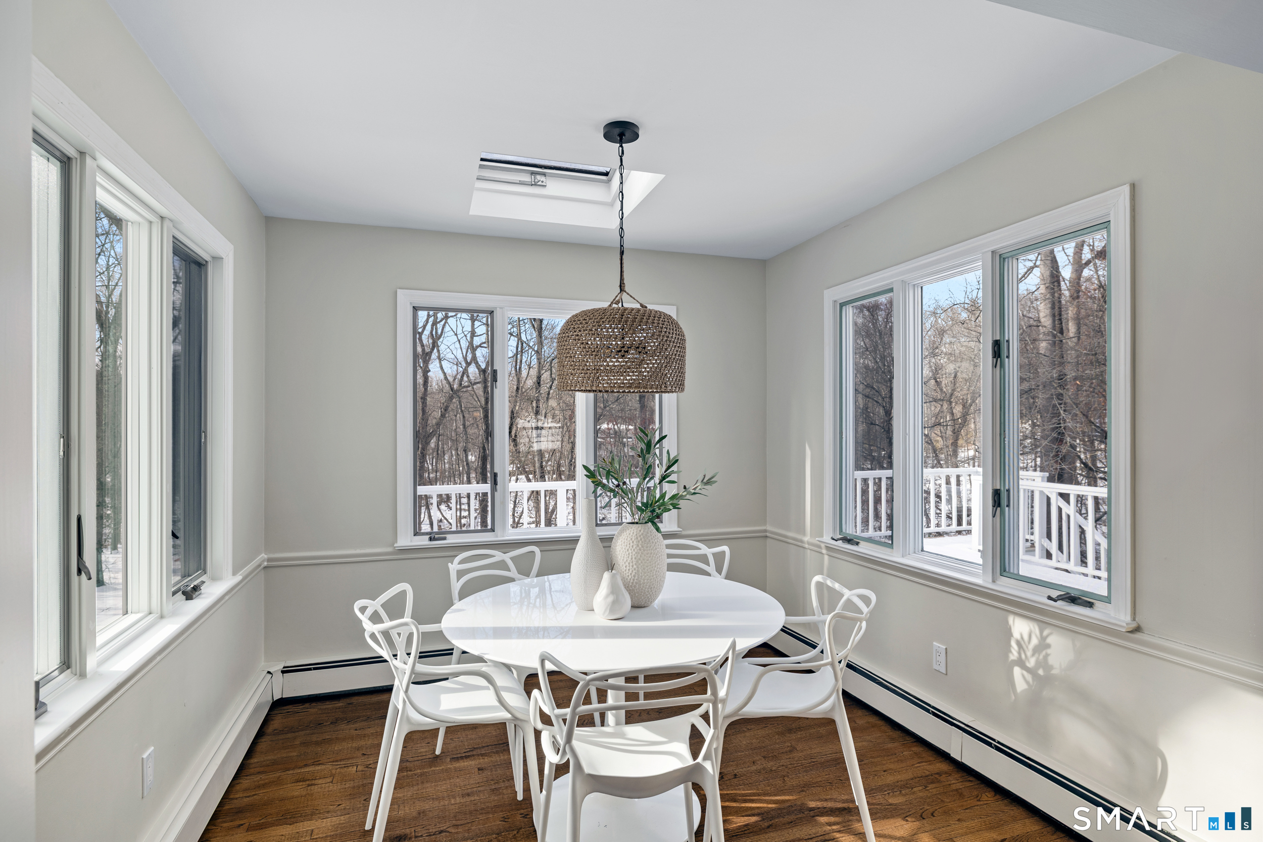 1038 West Road New Canaan, CT 06840 - Photo 15 of 37 a dining room with furniture a chandelier and wooden floor