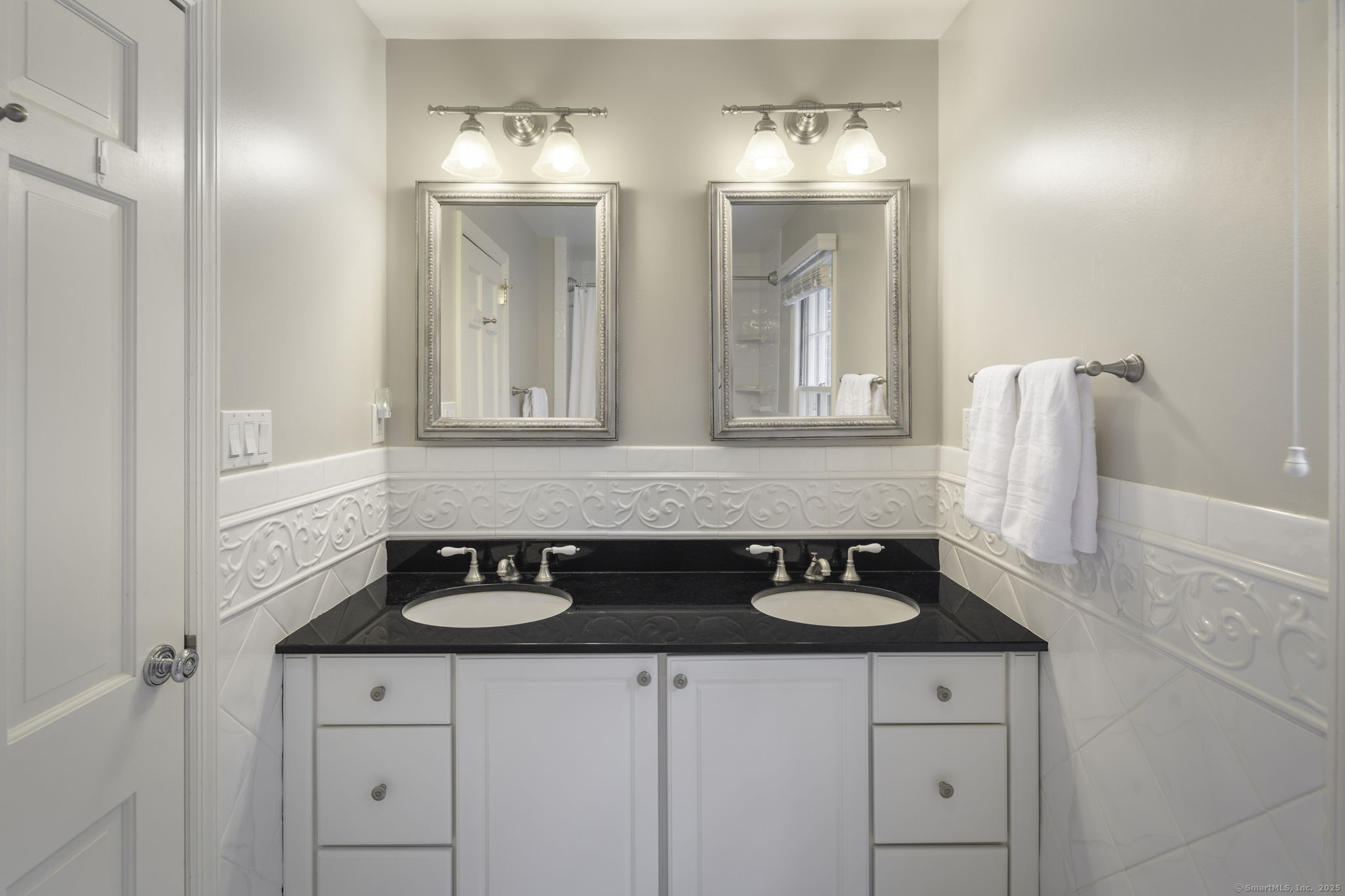 1038 West Road New Canaan, CT 06840 - Photo 26 of 37 a bathroom with a sink and a mirror