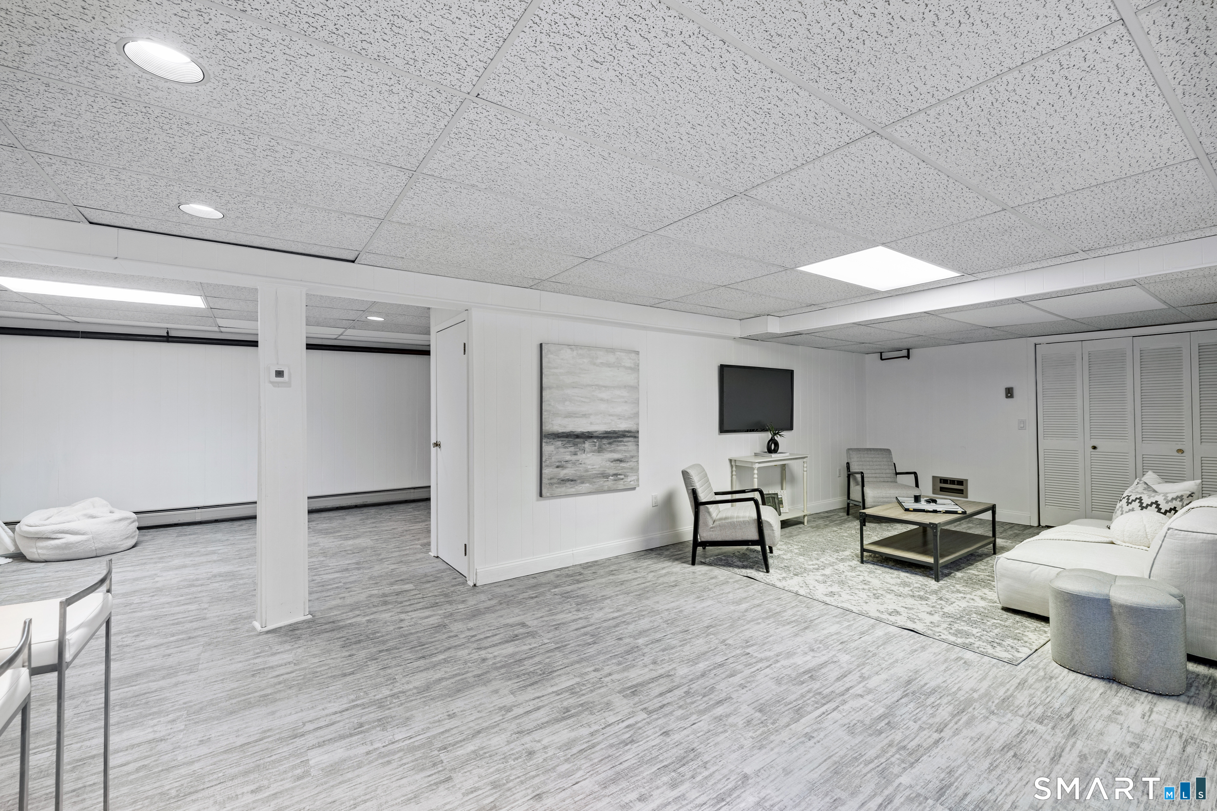 1038 West Road New Canaan, CT 06840 - Photo 31 of 37 a living room with furniture and a flat screen tv