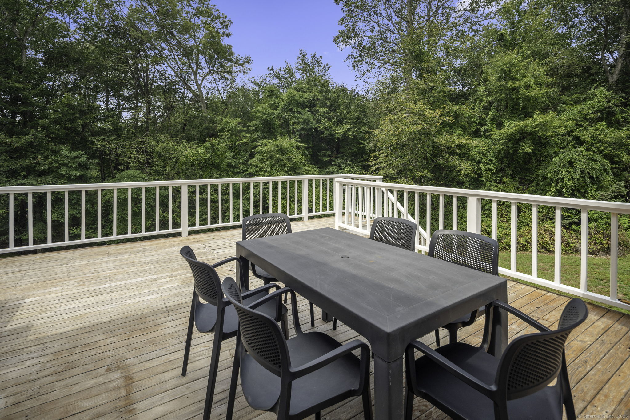 1038 West Road New Canaan, CT 06840 - Photo 35 of 37 a view of a deck with furniture and wooden deck