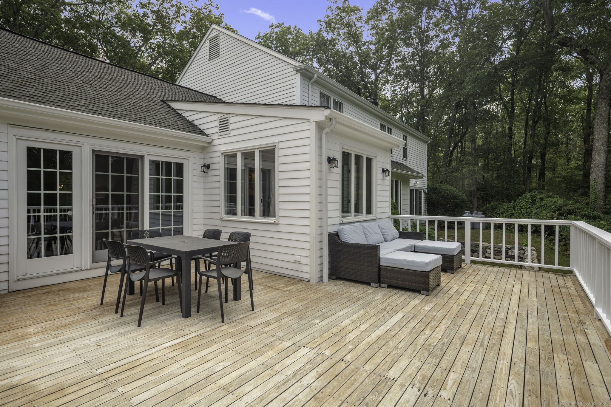 1038 West Road New Canaan, CT 06840 - Photo 36 of 37 a balcony with wooden floor table and chairs