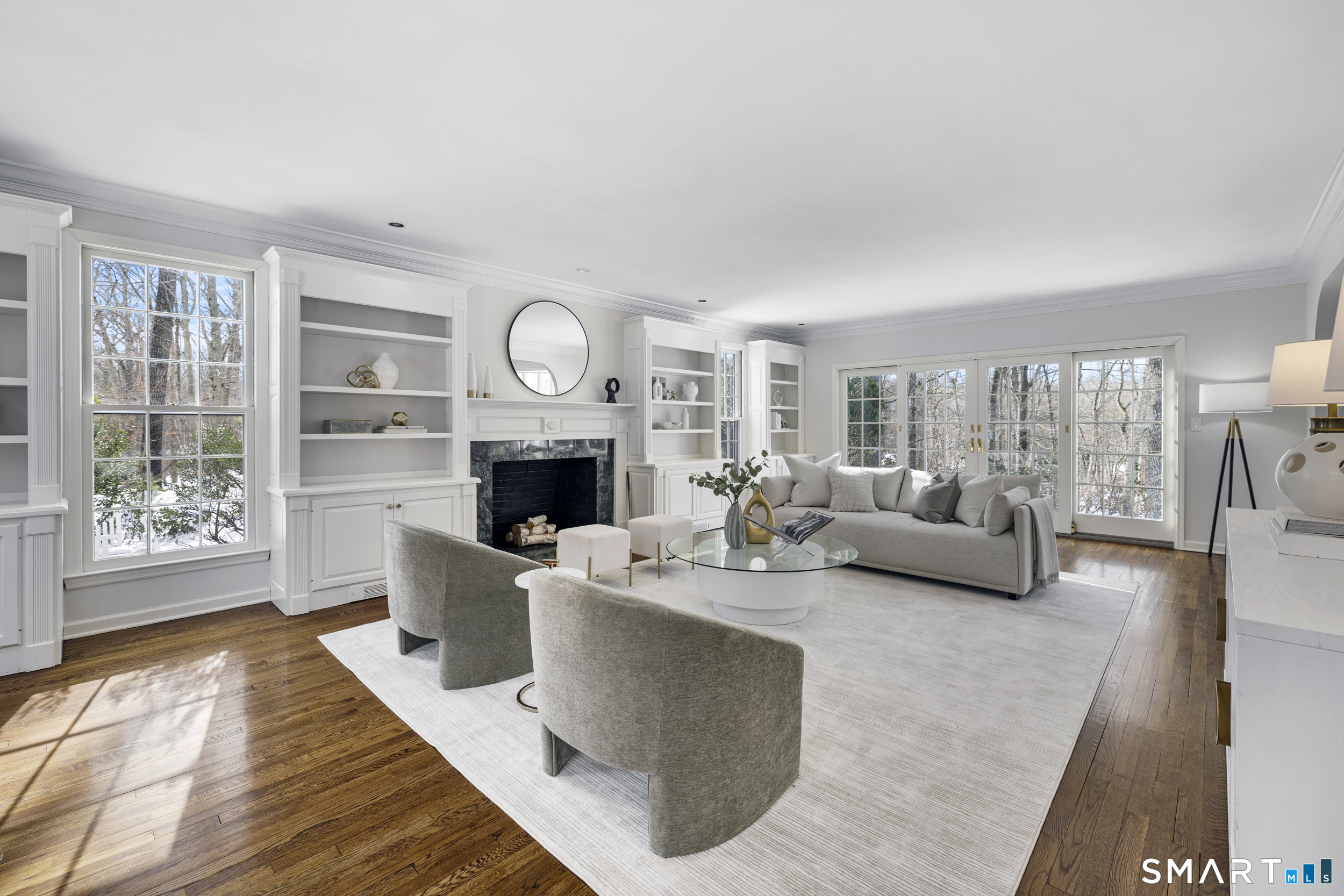 1038 West Road New Canaan, CT 06840 - Photo 4 of 37 a living room with furniture a fireplace and a large window