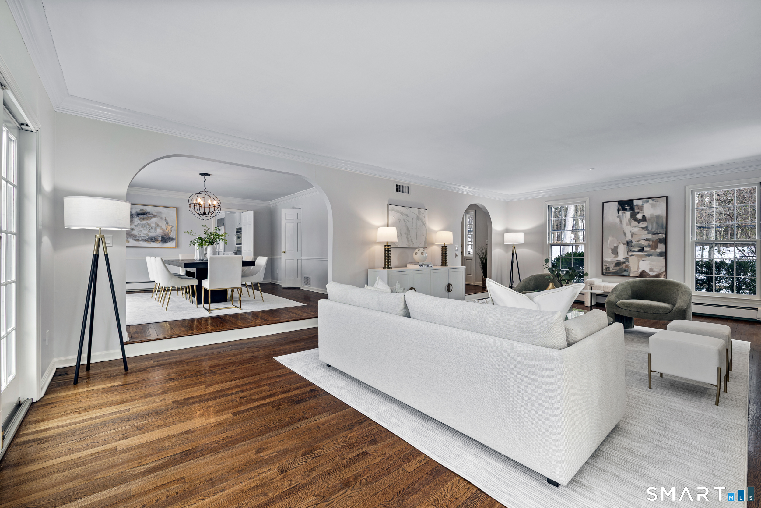 1038 West Road New Canaan, CT 06840 - Photo 6 of 37 a living room with furniture and a large mirror next to a window