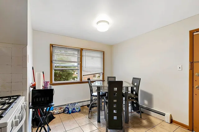 a view of a dining room with furniture and a window
