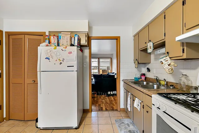 a kitchen with a refrigerator and a stove