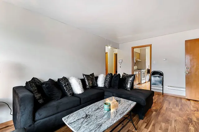 a living room with furniture and wooden floor