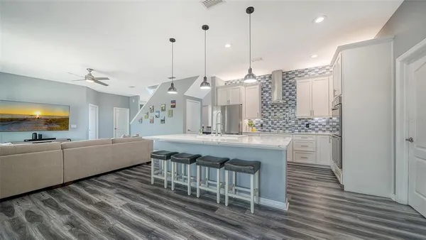 a kitchen with stainless steel appliances a refrigerator and a sink