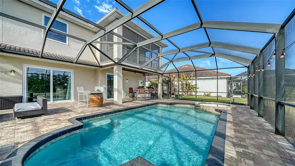 a swimming pool with outdoor seating and yard