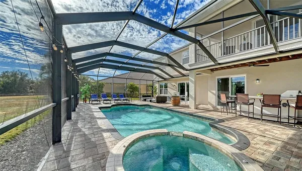 a view of a house with swimming pool and a garden