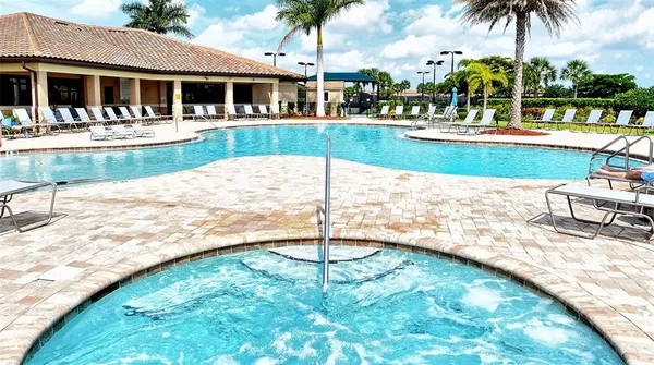 a view of swimming pool with a table and chairs