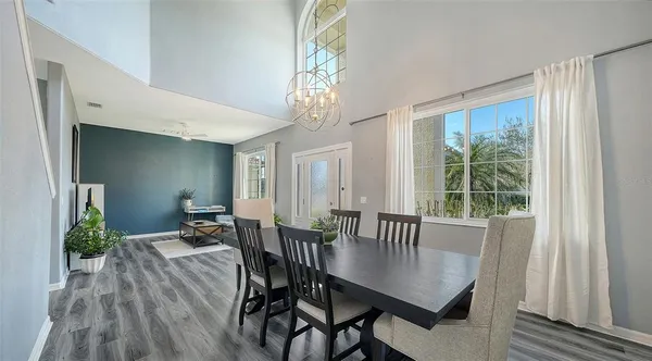 a living room with furniture and a ceiling fan