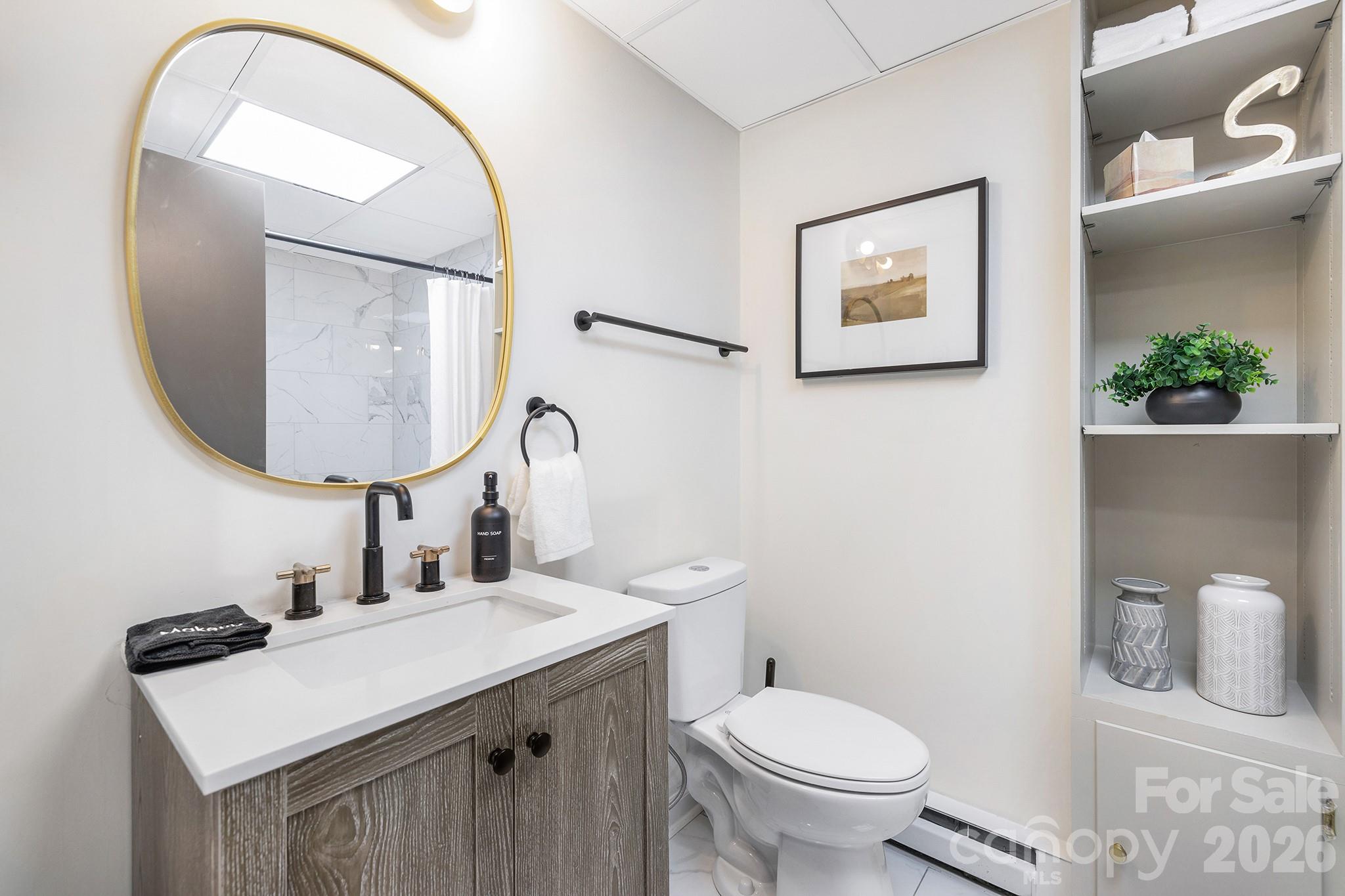 556-558 Thorncliff Drive Seven Devils, NC 28604 - Photo 23 of 48 a bathroom with a toilet a sink and mirror