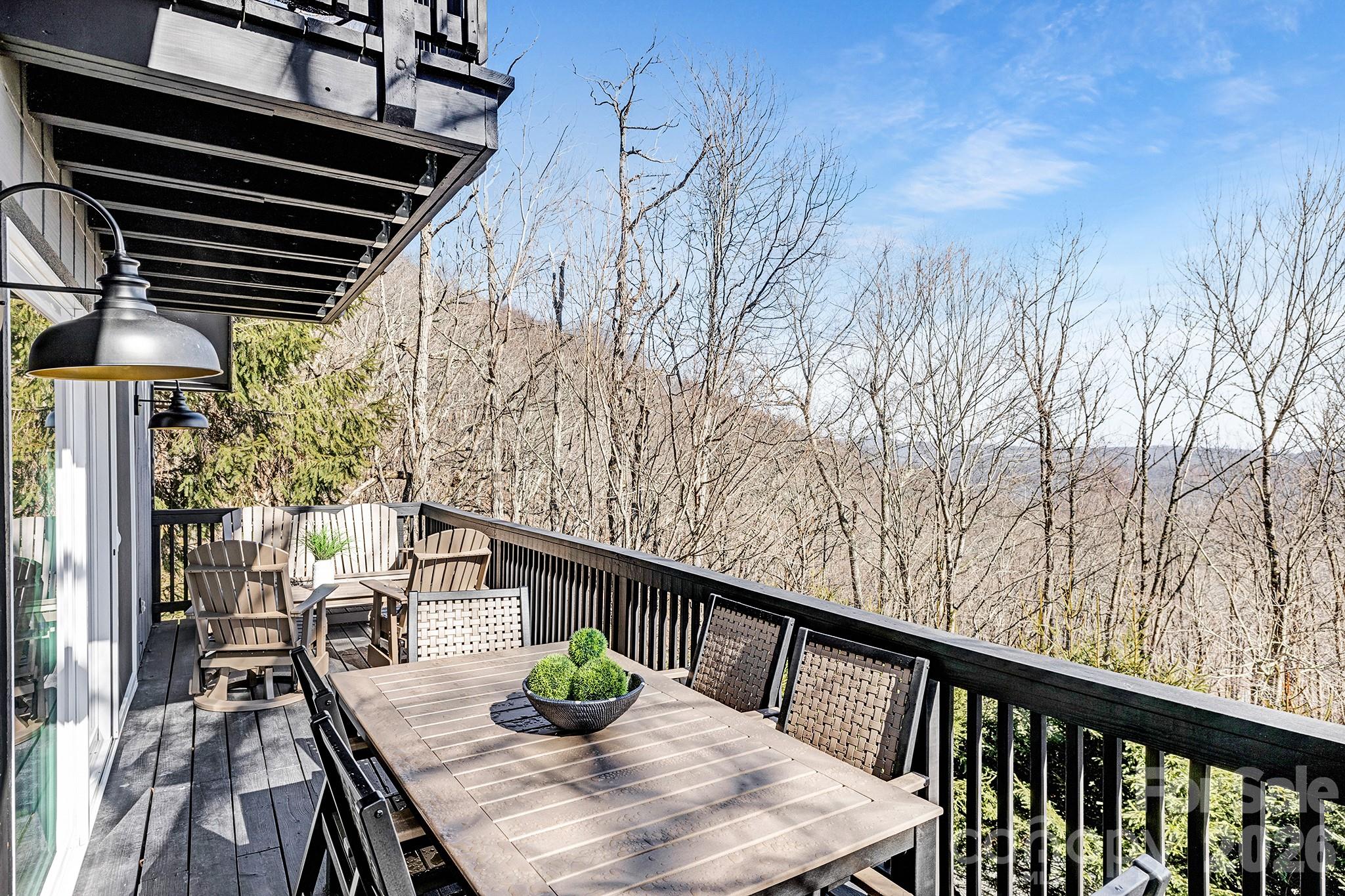 556-558 Thorncliff Drive Seven Devils, NC 28604 - Photo 34 of 48 a balcony with wooden floor and outdoor seating