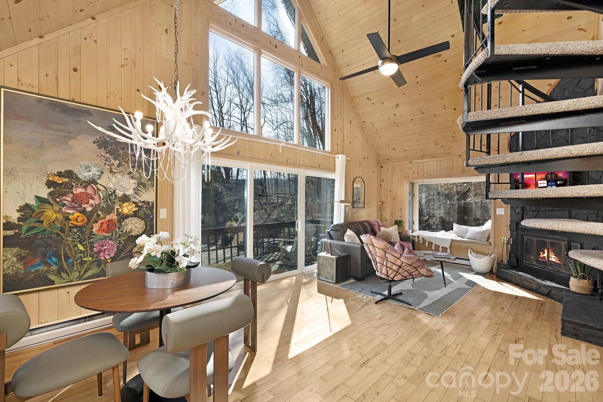 556-558 Thorncliff Drive Seven Devils, NC 28604 - Photo 40 of 48 a living room with furniture a fireplace and a floor to ceiling window