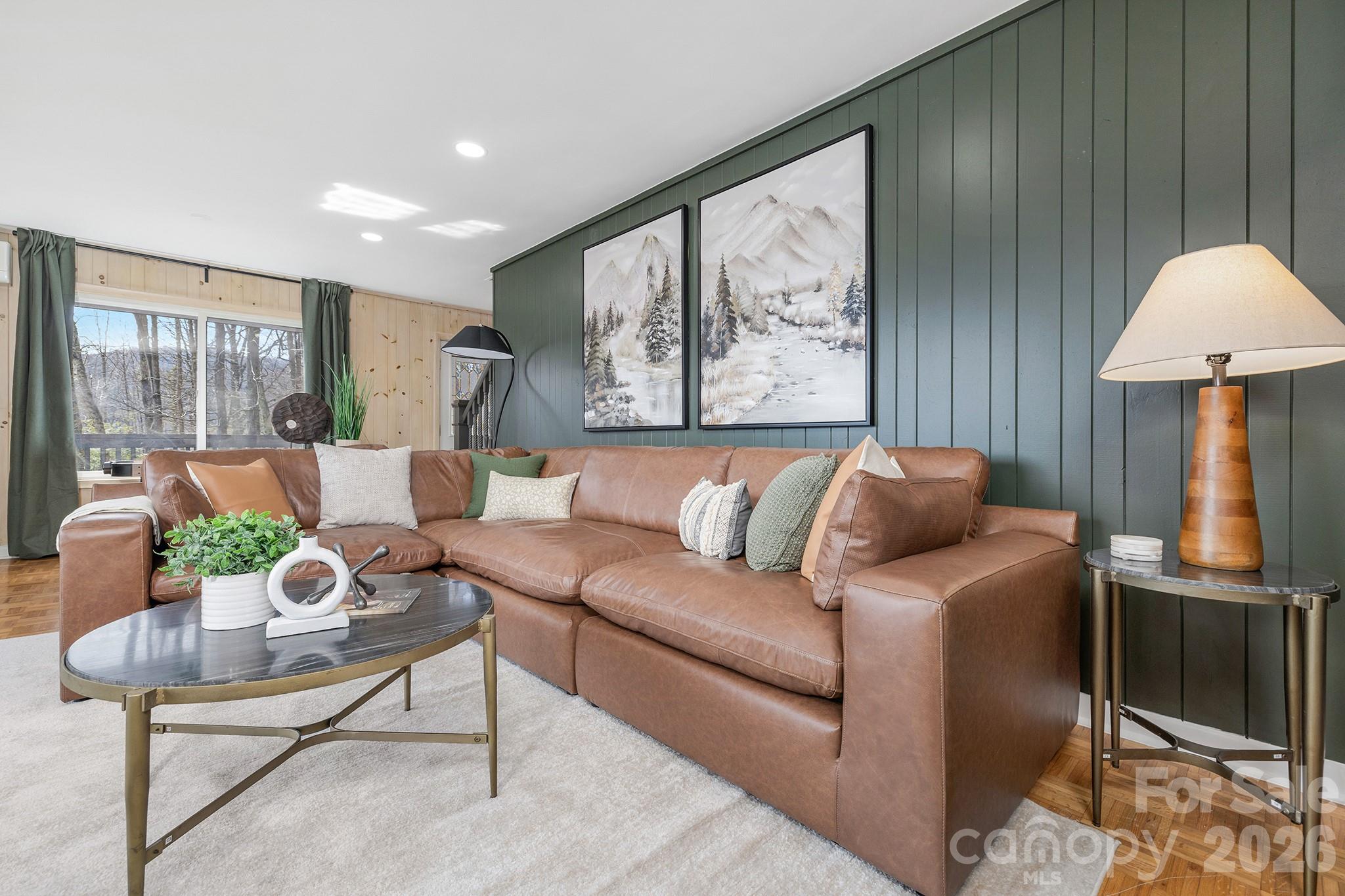 556-558 Thorncliff Drive Seven Devils, NC 28604 - Photo 4 of 48 a living room with furniture and a lamp