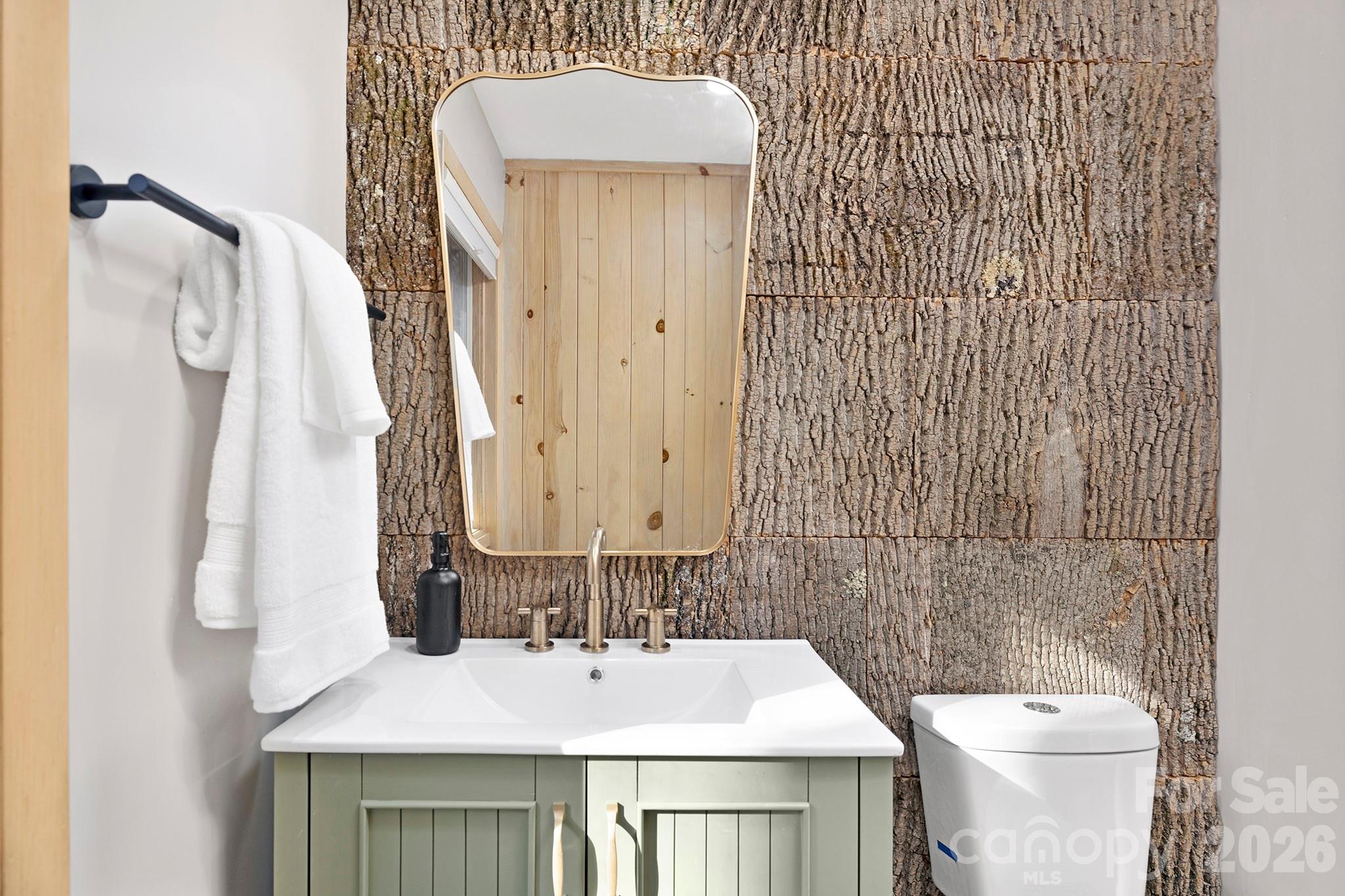 556-558 Thorncliff Drive Seven Devils, NC 28604 - Photo 47 of 48 a bathroom with a sink and mirror with toilet