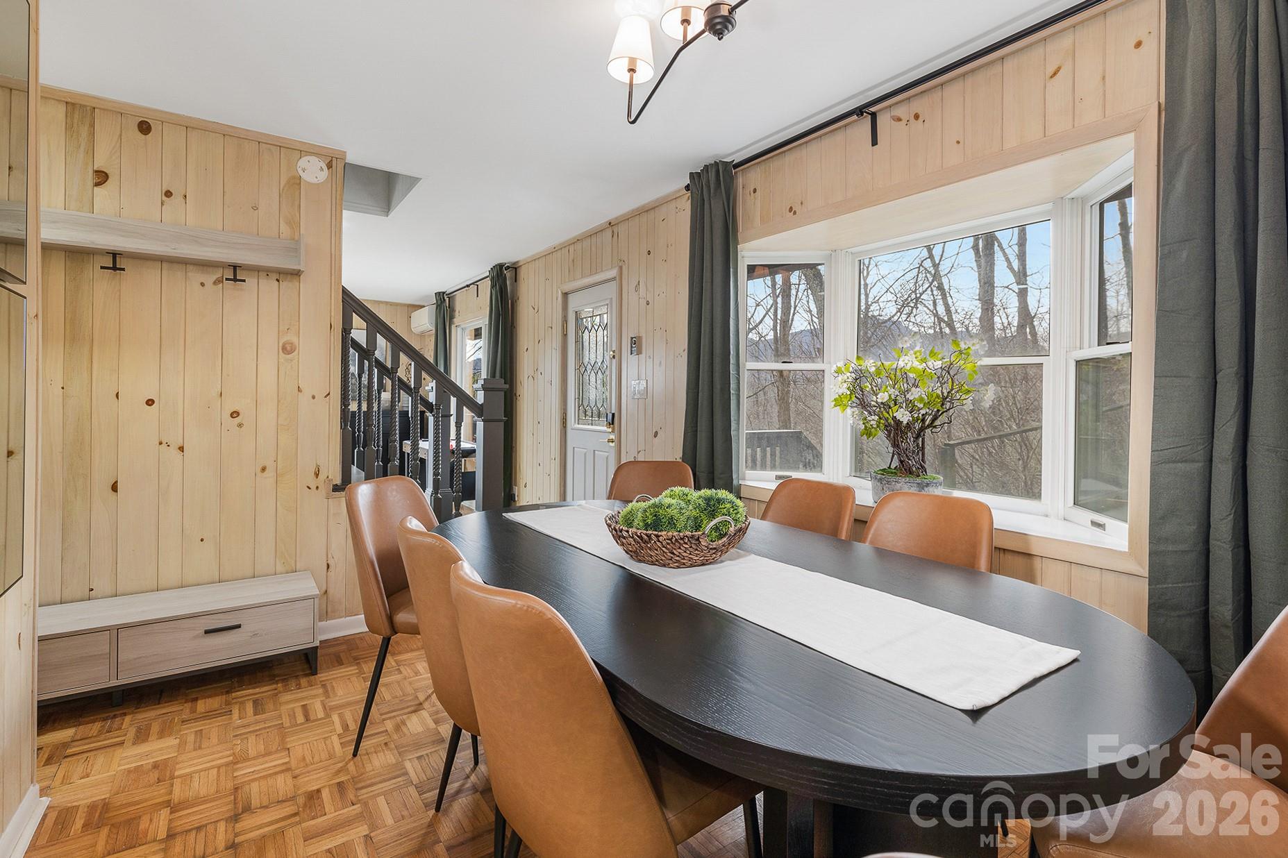 556-558 Thorncliff Drive Seven Devils, NC 28604 - Photo 8 of 48 a view of a dining room with furniture window and wooden floor