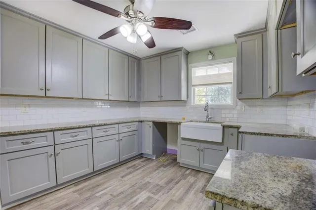 a kitchen with stainless steel appliances granite countertop a sink and cabinets
