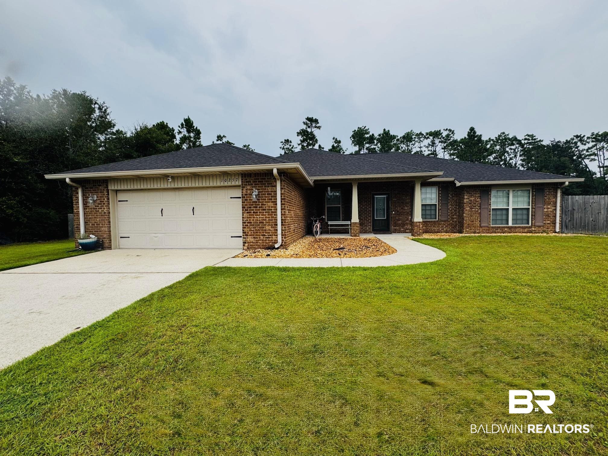 10257 Lyttleton Loop Lillian, AL 36549 - Photo 25 of 31 Ranch-style home featuring brick siding, a front yard, concrete driveway, and a garage